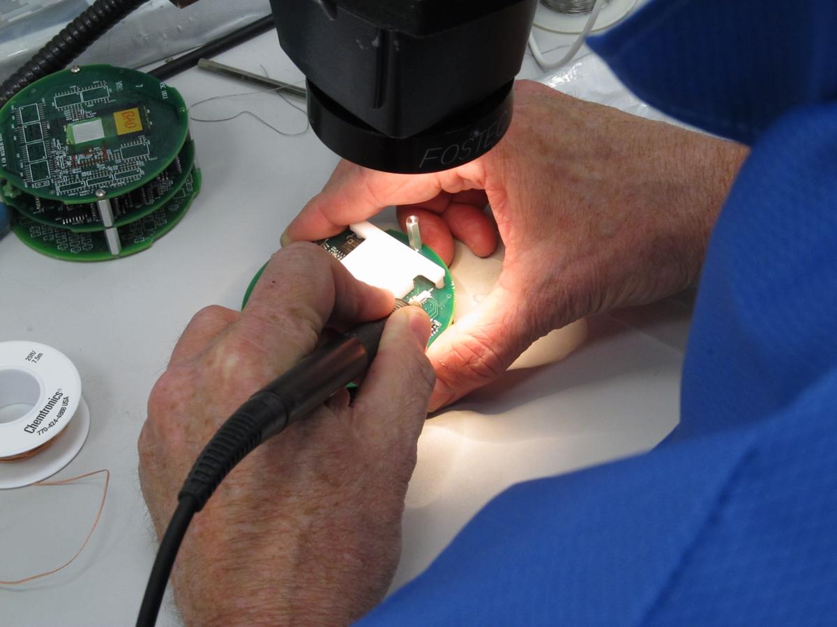 Researcher working on a FOXSI-1 detector board.