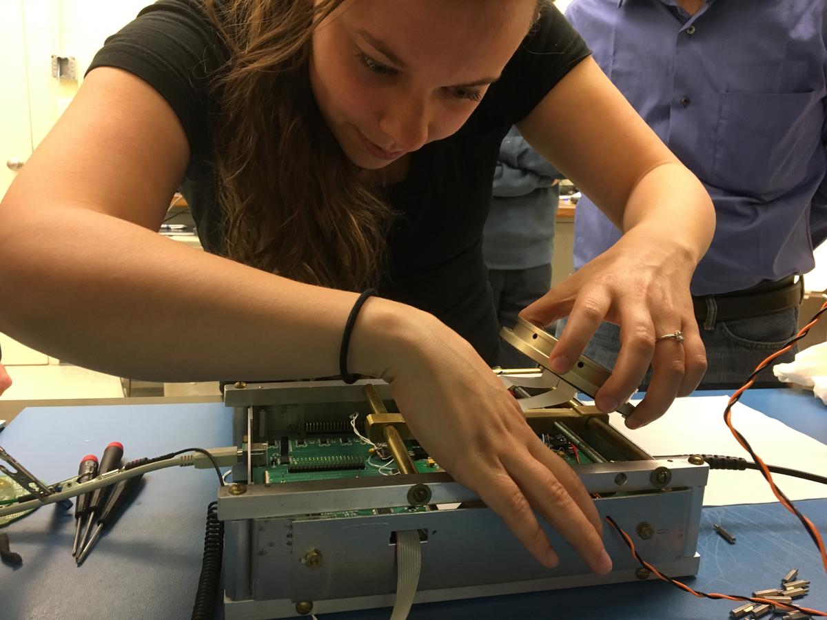 Researcher arranging FOXSI-3 detectors in the cooling system